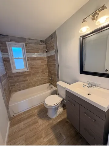 a bathroom with a toilet a sink and bathtub