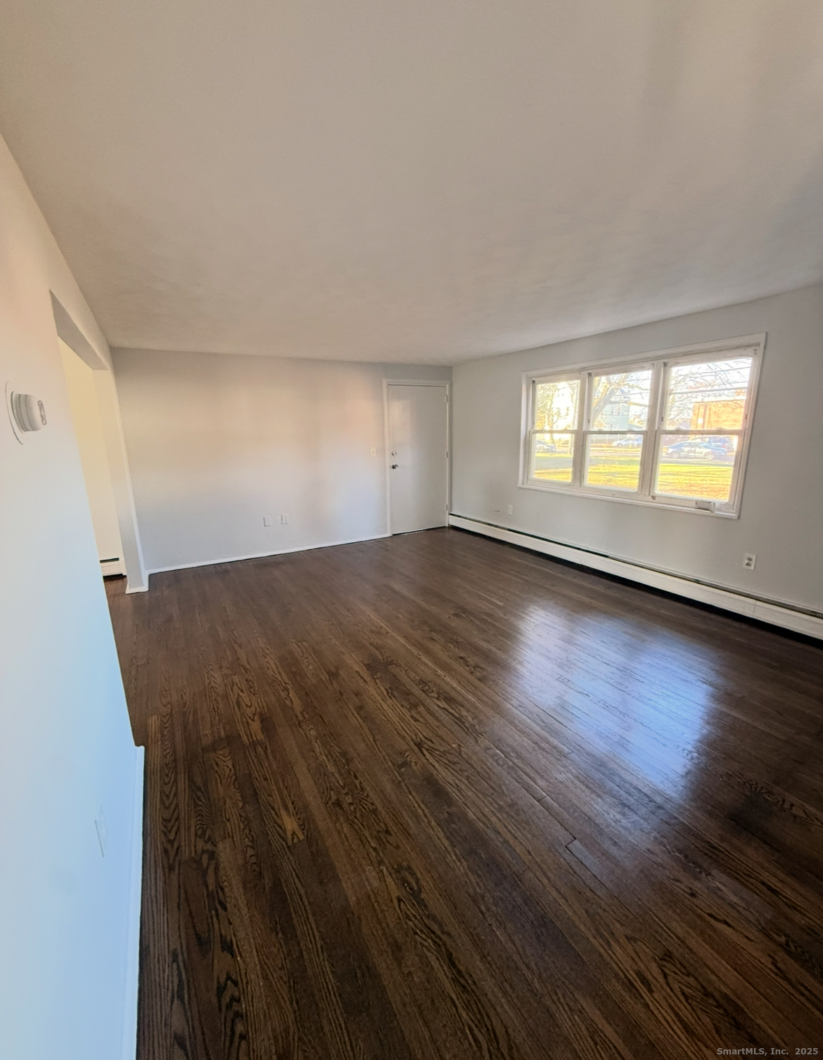 1275 Quinnipiac Avenue, Unit 9 New Haven, CT 06513 - Photo 5 of 6 an empty room with wooden floor and windows