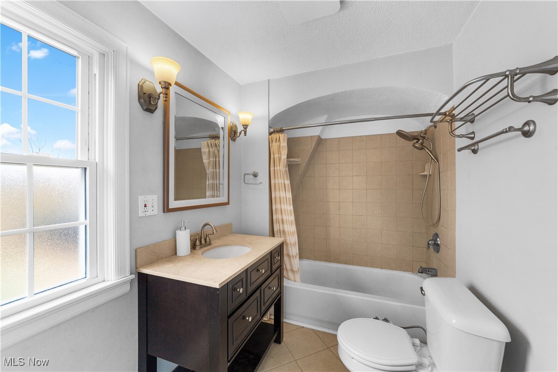 2492 Channing Road Cleveland, OH 44118 - Photo 11 of 14 2nd floor Full bathroom with tile patterned flooring, shower / bath combination with curtain, a textured ceiling, toilet, and vanity