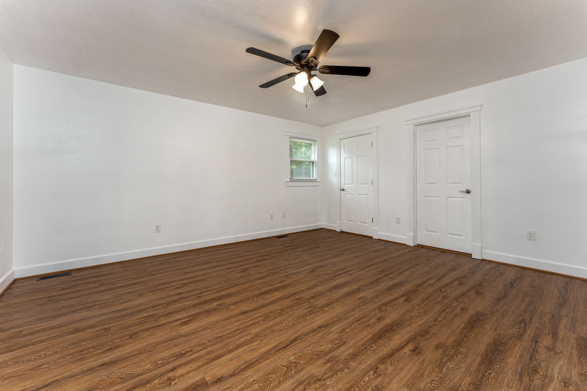 7 South Patrick Road Fayetteville, TN 37334 - Photo 22 of 32 a view of an empty room with wooden floor and a ceiling fan