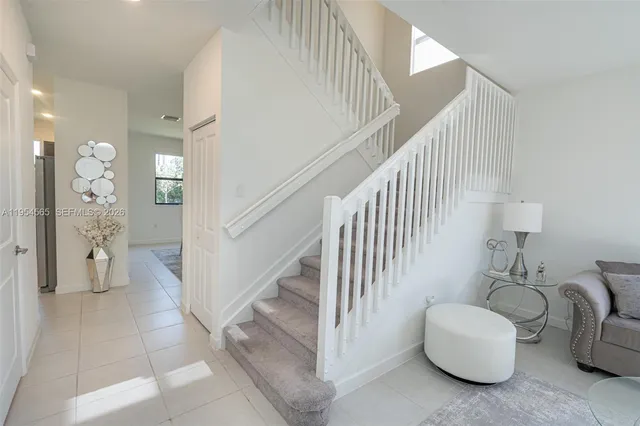 a kitchen with a sink window and cabinets