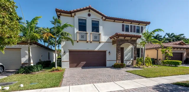 a front view of house with a garden