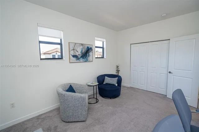 a bedroom with a bed and a chair