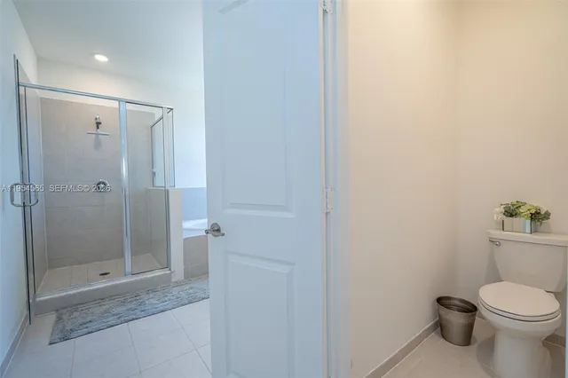 a view of a swimming pool with a chair and palm trees