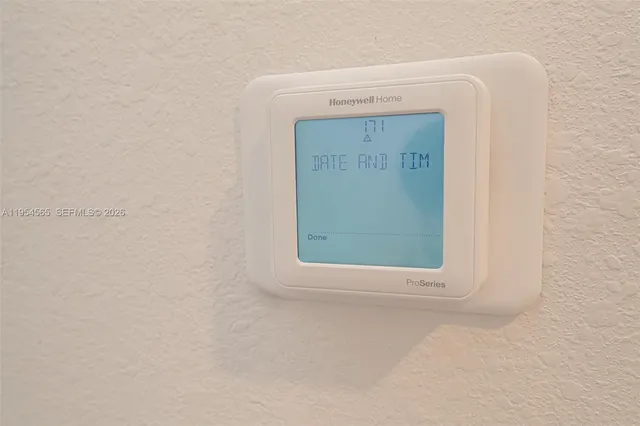 a view of a patio with a table and chairs under an umbrella