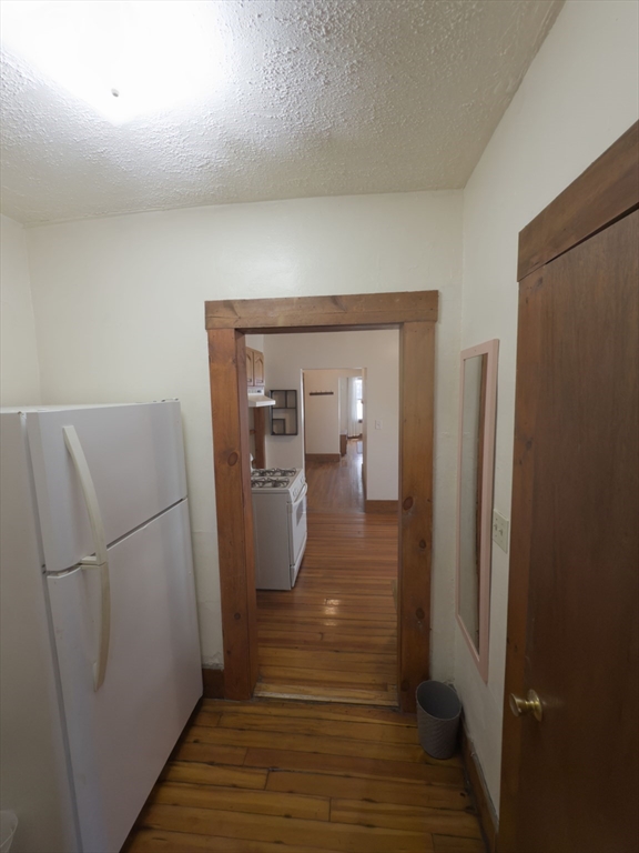 3965 Washington Street Boston, MA 02131 - Photo 10 of 18 a view of a hallway with wooden floor and closet