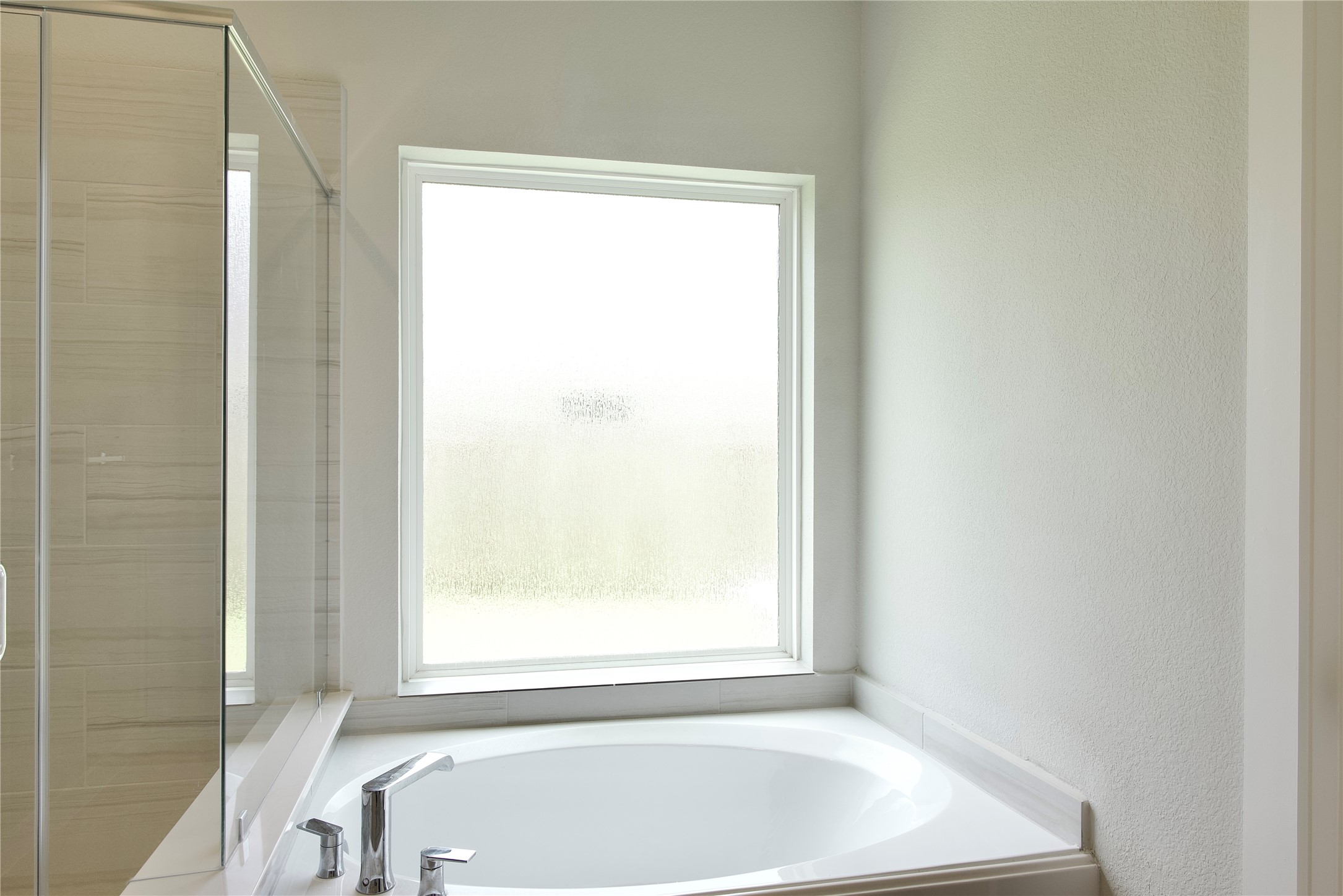 3207 Tilley Drive Rosenberg, TX 77471 - Photo 28 of 43 a white bath tub sitting next to a window