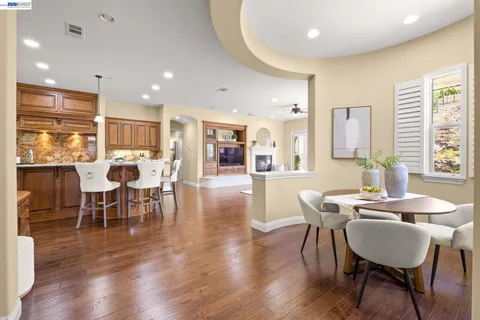a view of a dining room with furniture and wooden floor