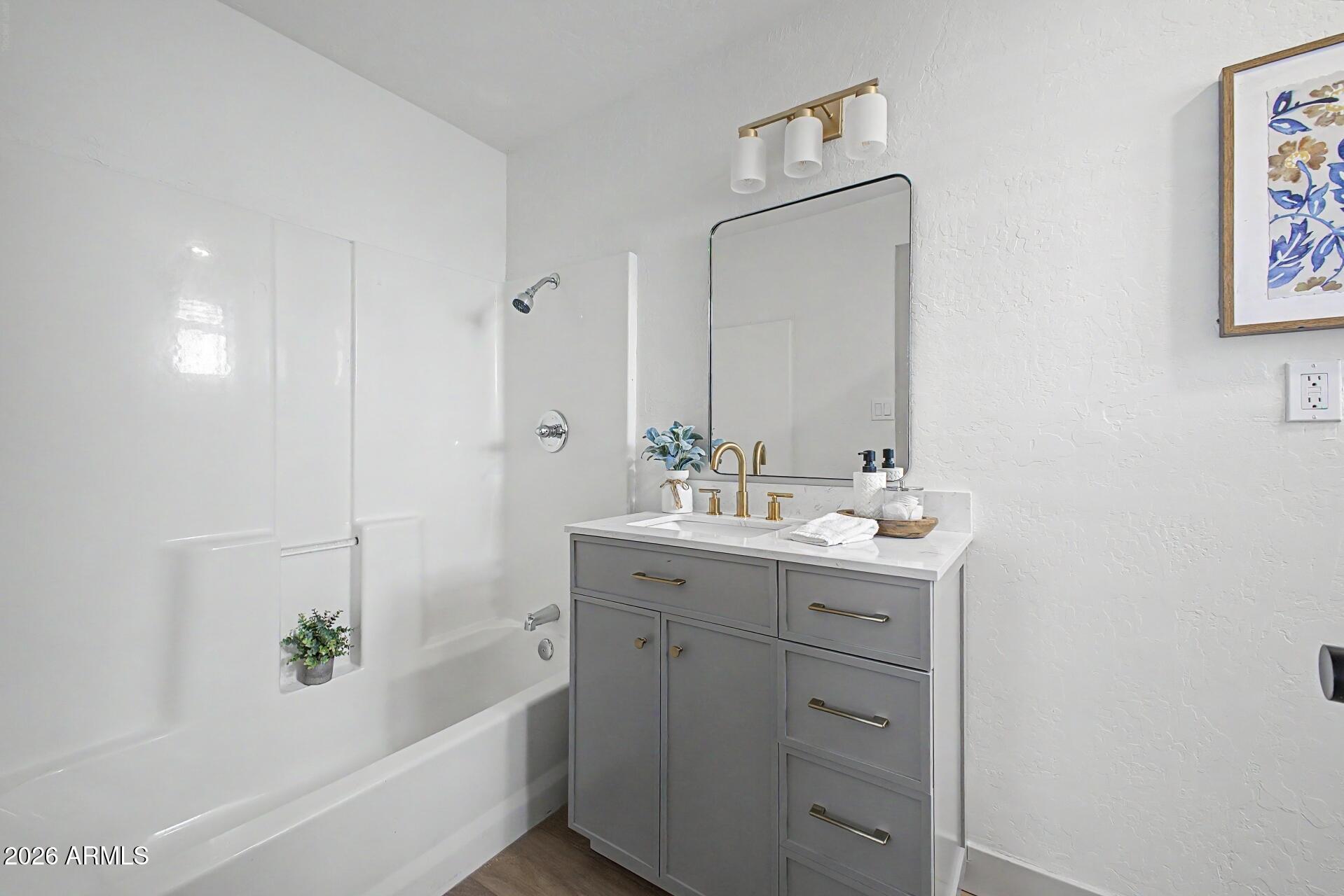 1914 East Monte Vista Road Phoenix, AZ 85006 - Photo 14 of 26 a bathroom with a tub sink and mirror