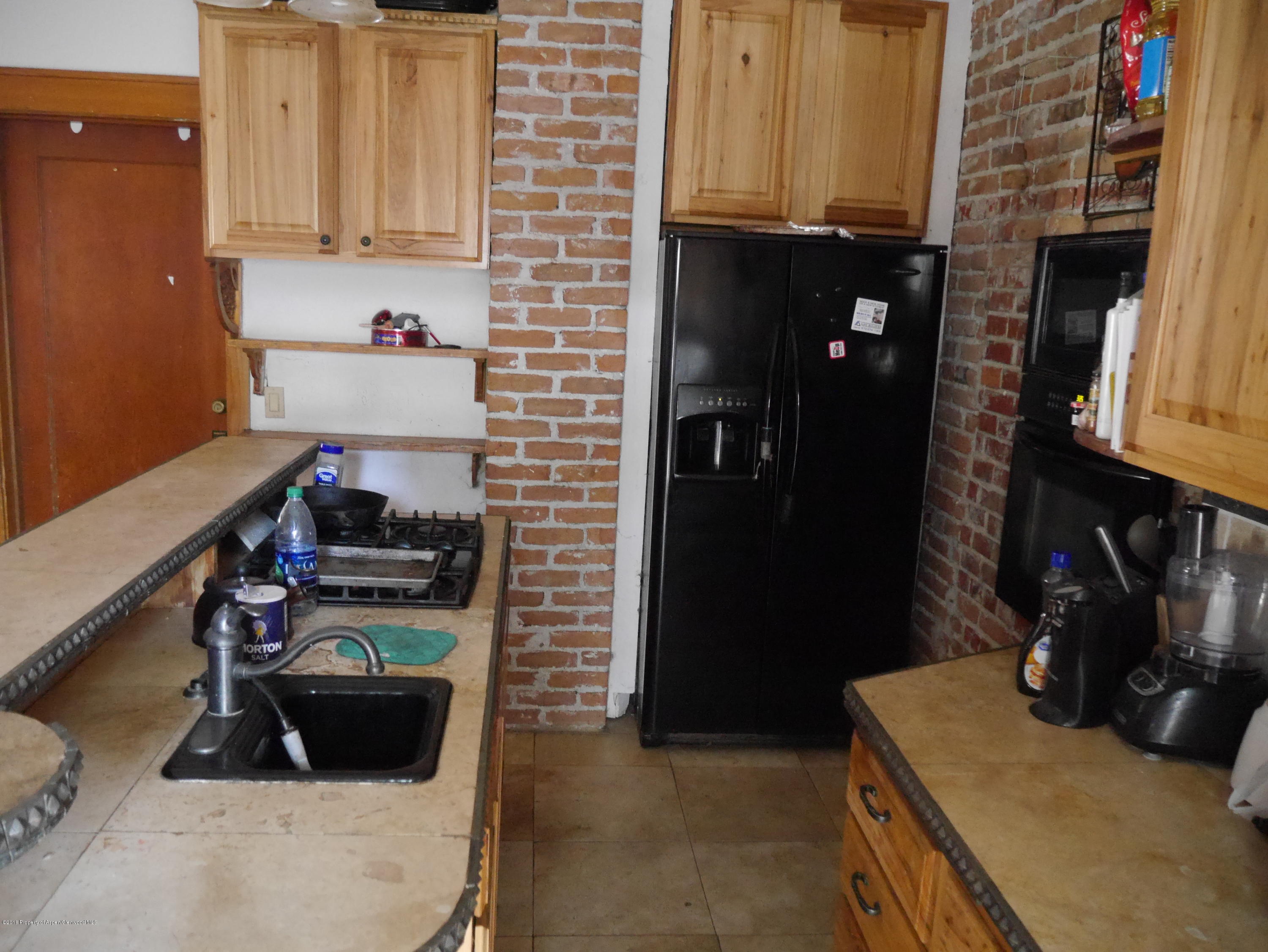 425 West 3rd Street Rifle, CO 81650 - Photo 13 of 14 a room with furniture and a fireplace