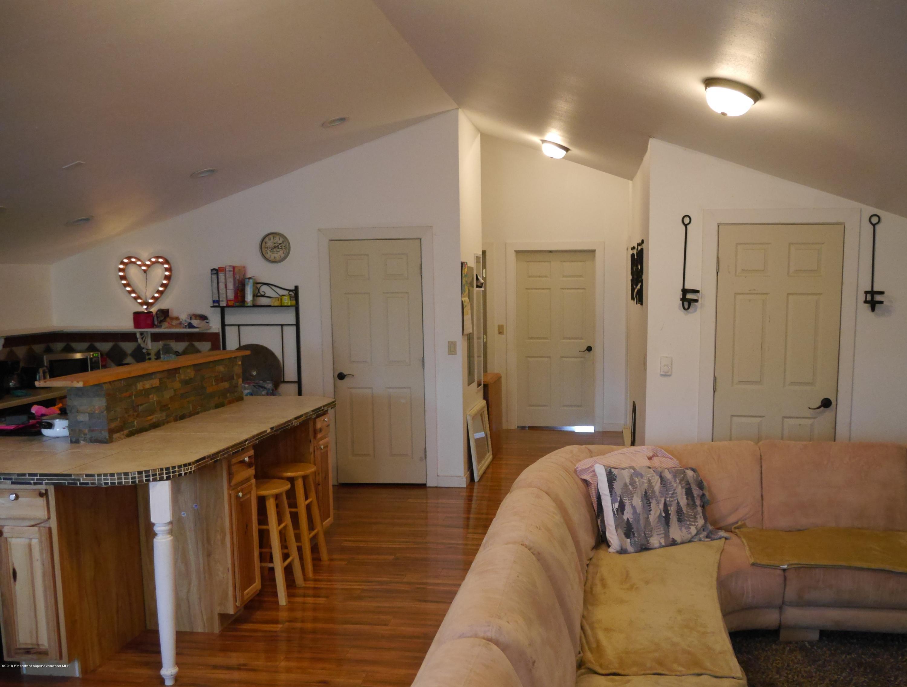 425 West 3rd Street Rifle, CO 81650 - Photo 7 of 14 a bed room with a bed and a couch