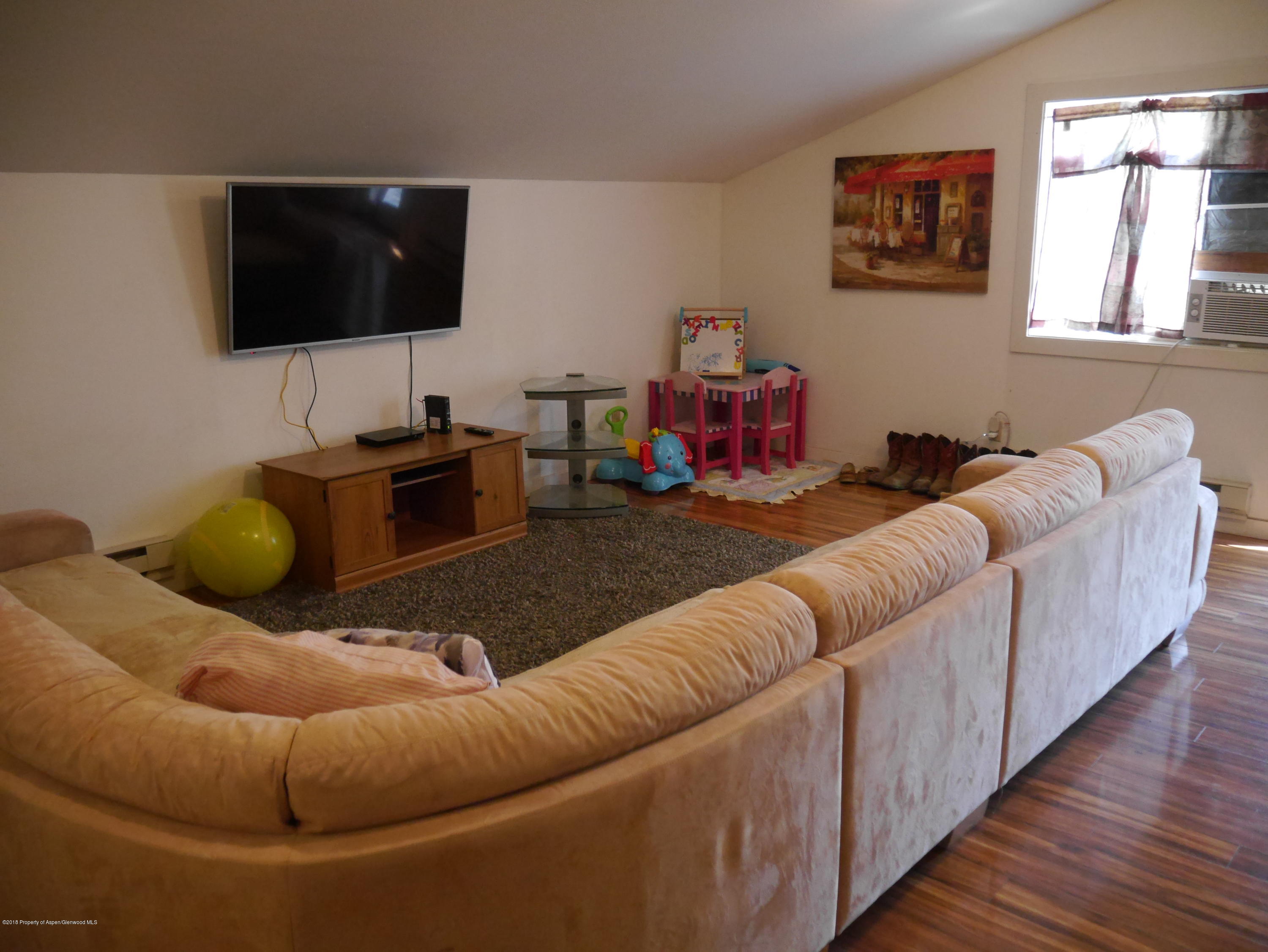 425 West 3rd Street Rifle, CO 81650 - Photo 9 of 14 a living room with furniture and a flat screen tv