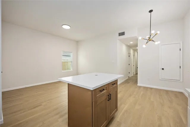 a kitchen with a wooden floor and window