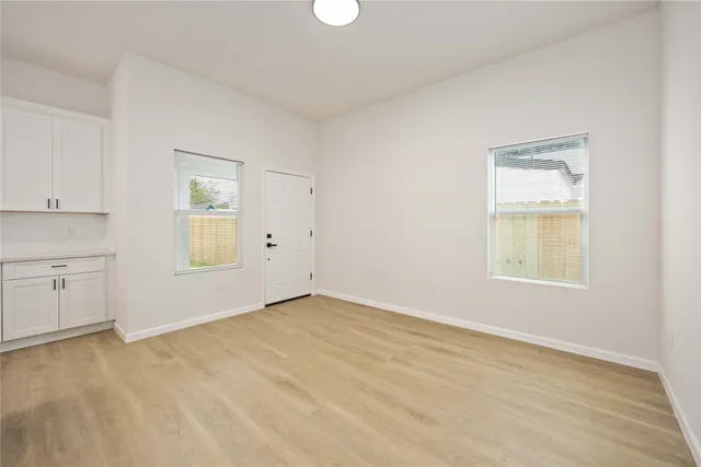 an empty room with windows and closet