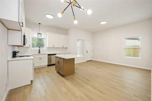 a kitchen with a sink cabinets and window