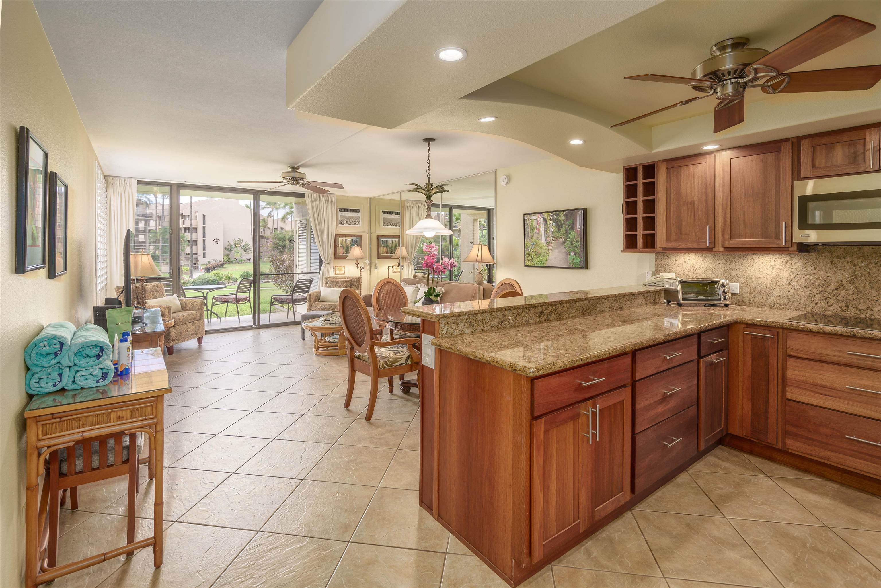 2695 South Kihei Road, Unit 2102 Kihei, HI 96753 - Photo 1 of 35 a open kitchen with stainless steel appliances granite countertop a stove and cabinets