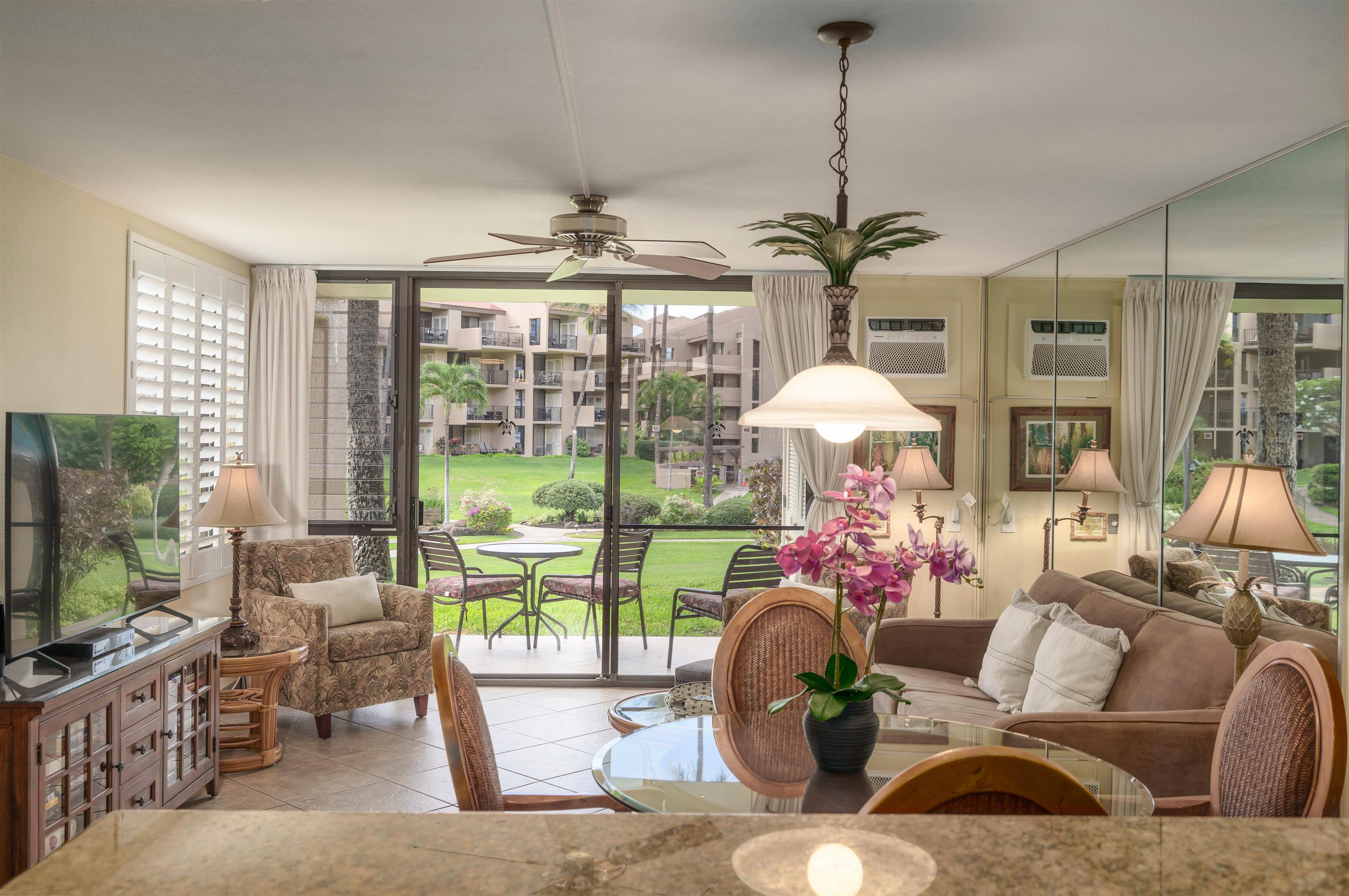 2695 South Kihei Road, Unit 2102 Kihei, HI 96753 - Photo 12 of 35 a living room with patio furniture and a chandelier