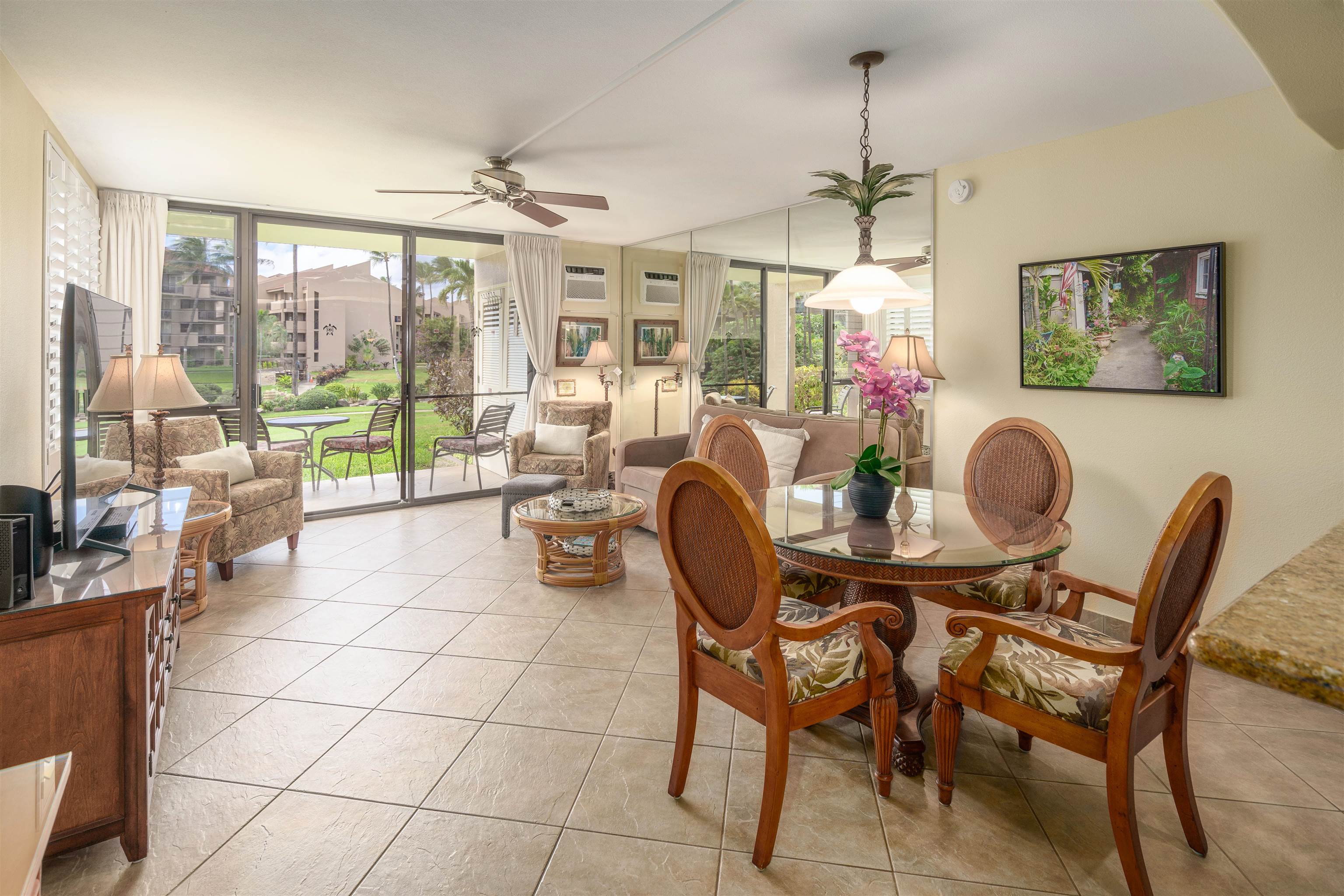 2695 South Kihei Road, Unit 2102 Kihei, HI 96753 - Photo 14 of 35 a view of a dining room with furniture wooden floor and a chandelier