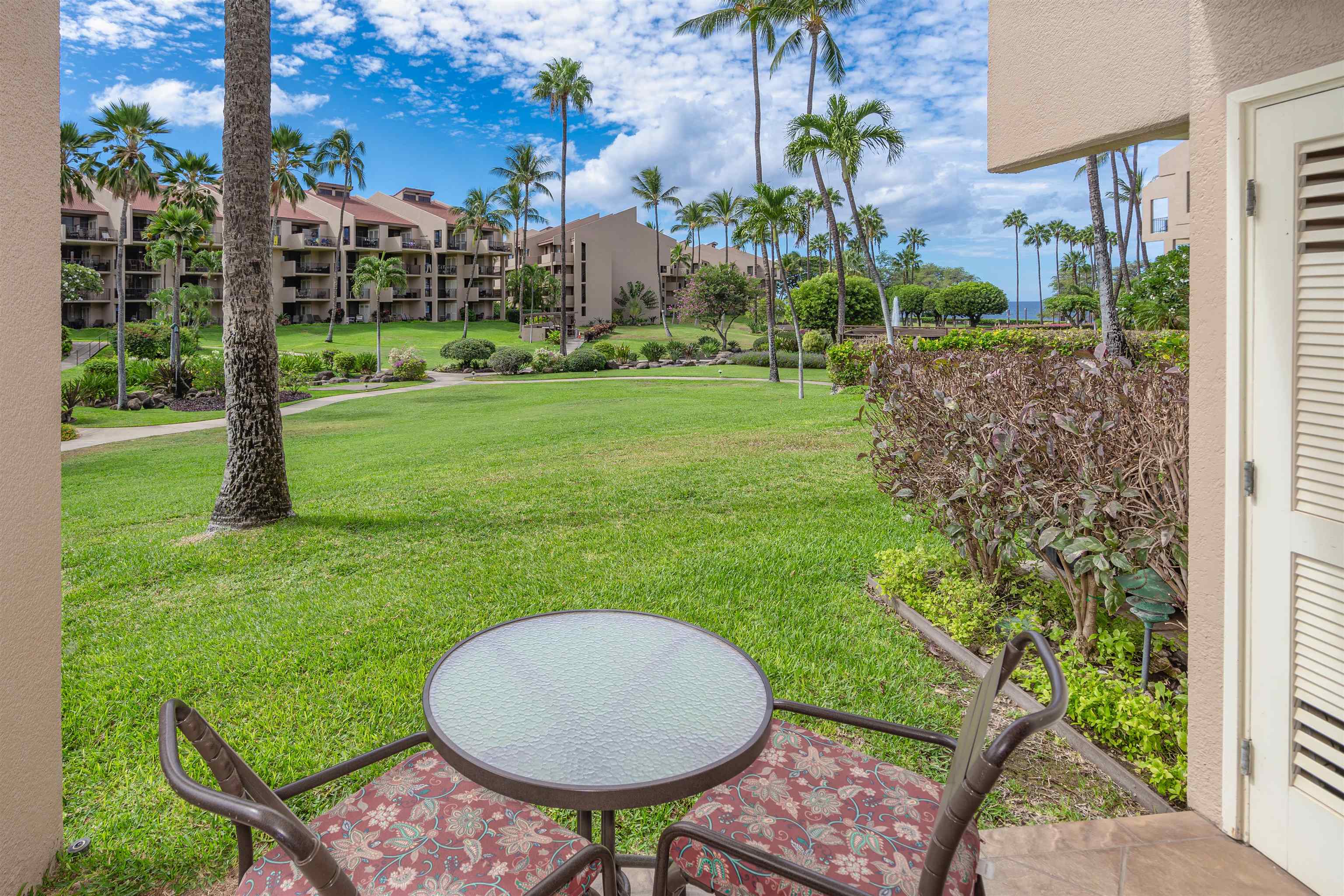 2695 South Kihei Road, Unit 2102 Kihei, HI 96753 - Photo 18 of 35 a view of a chair and table in the garden