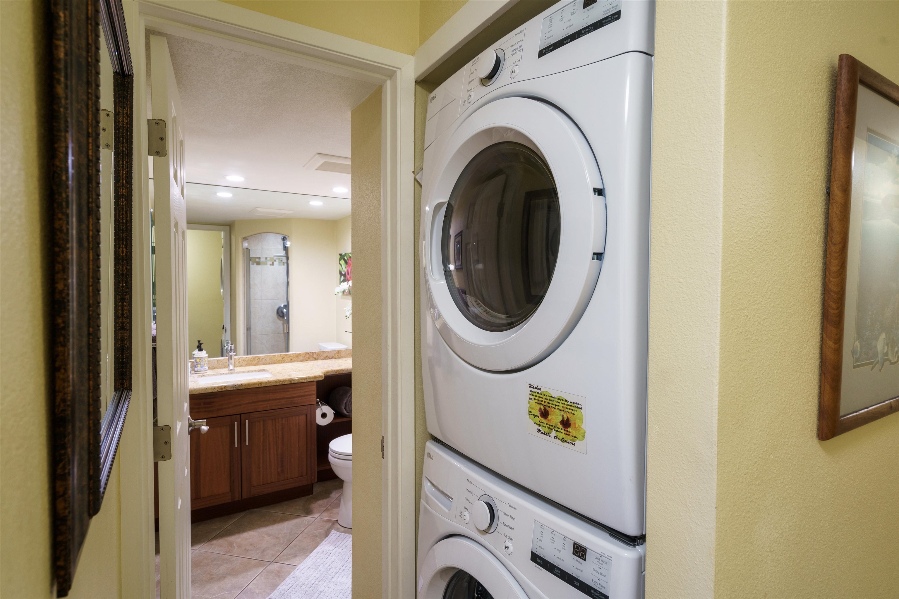 2695 South Kihei Road, Unit 2102 Kihei, HI 96753 - Photo 22 of 35 a view of a hallway with washer and dryer