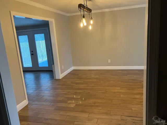 an empty room with wooden floor and closet