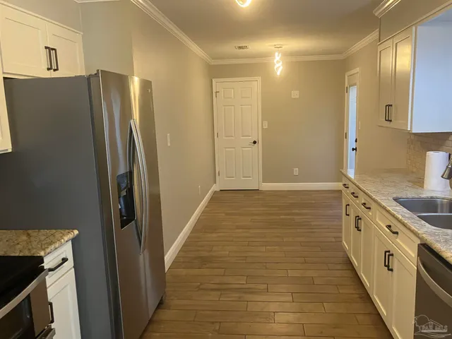 a stove top oven sitting inside of a kitchen