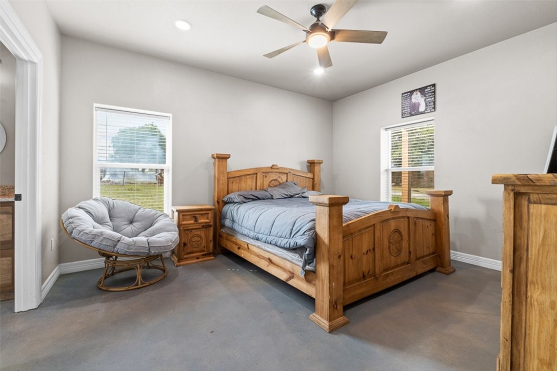 207 South Charles Street George West, TX 78022 - Photo 20 of 24 a bedroom with a bed and a chair