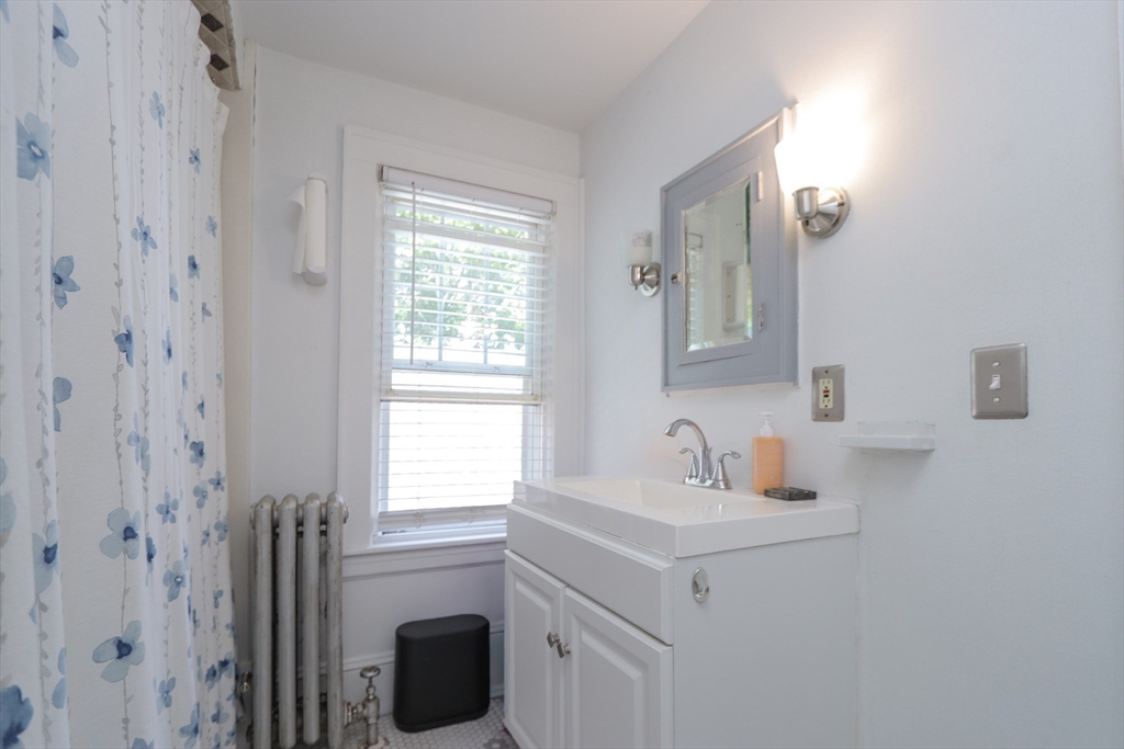 34 Preston Street Springfield, MA 01109 - Photo 20 of 34 a bathroom with a sink a toilet and a window