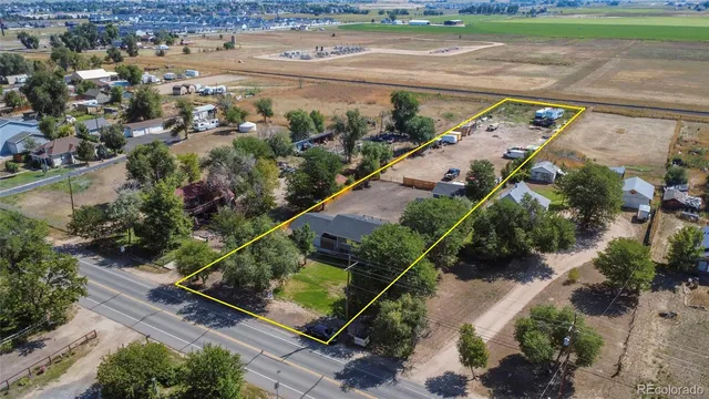 an aerial view of a house with a yard and lake view