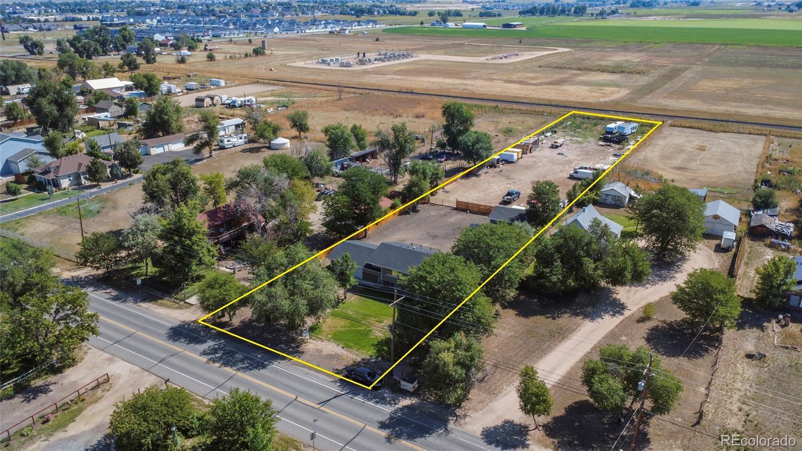 an aerial view of a house with a yard and lake view