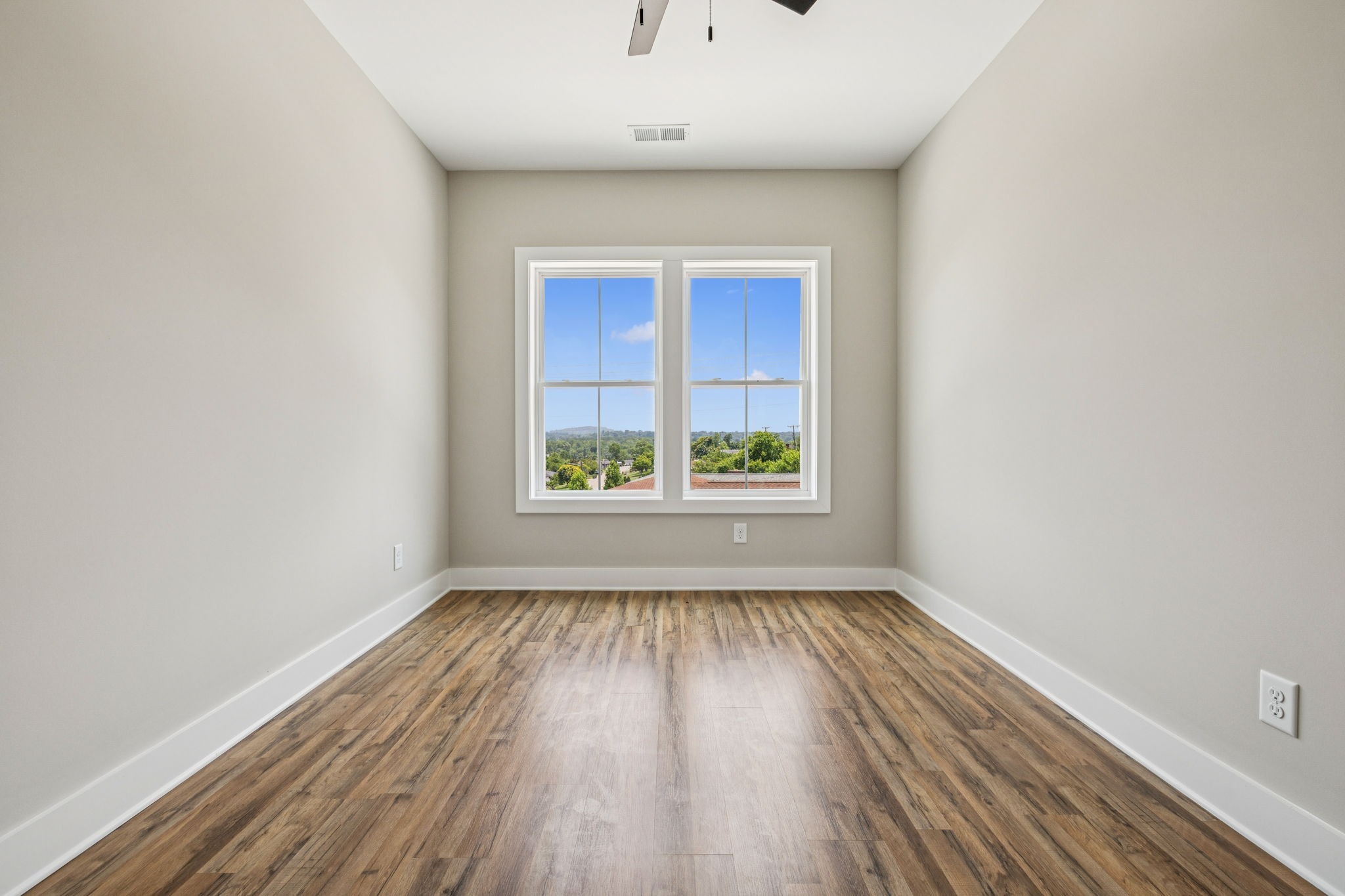 257 B Riverside Drive Nashville, TN 37206 - Photo 32 of 56 a view of an empty room with wooden floor and a window