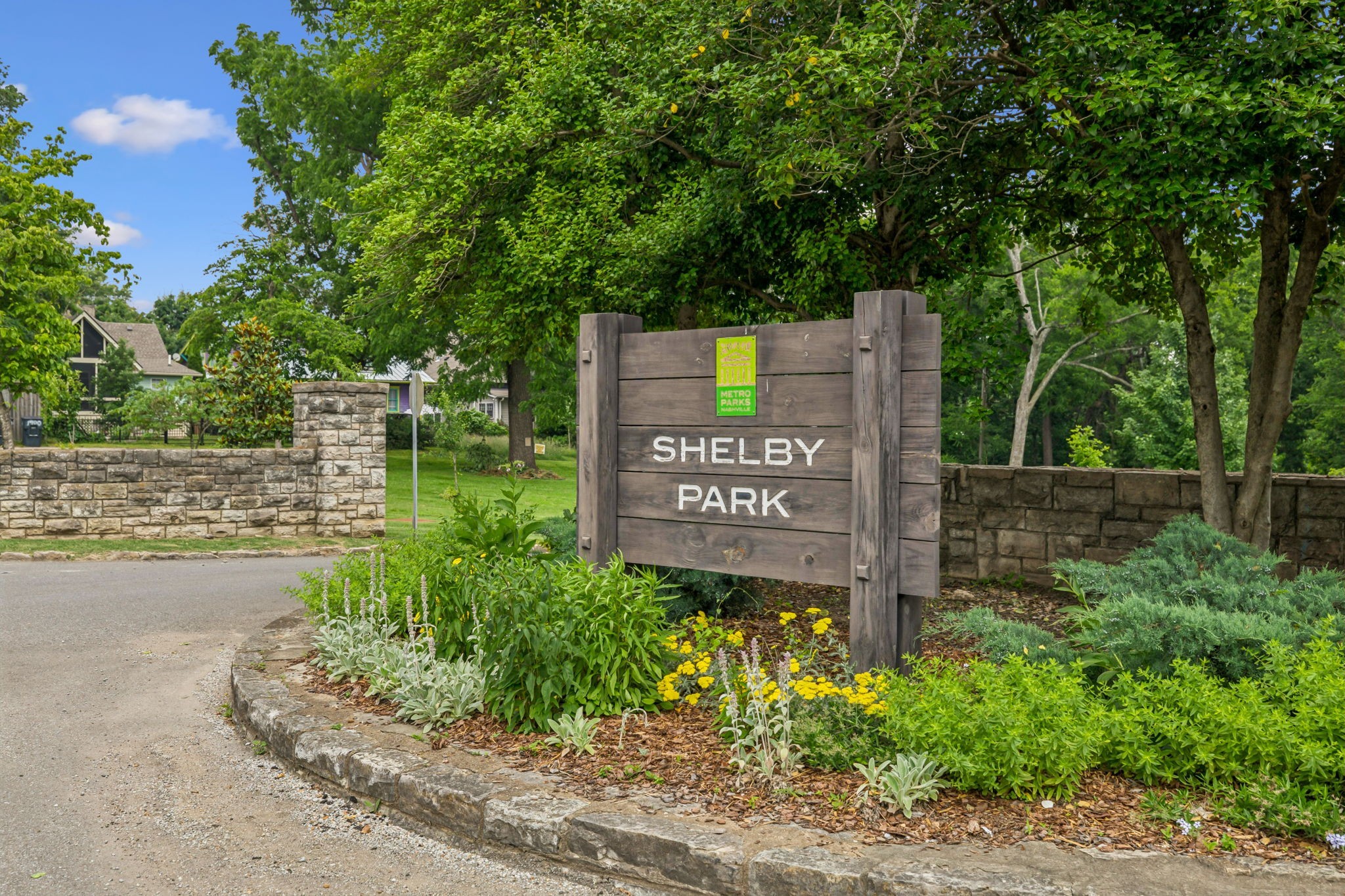 257 B Riverside Drive Nashville, TN 37206 - Photo 38 of 56 a sign that is sitting in front of a brick house with large trees