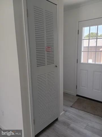 a view of a small space with wooden floor and a window