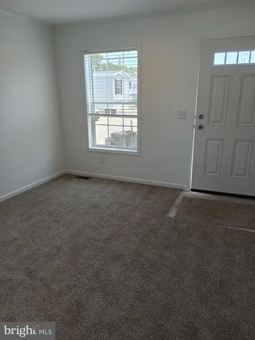 an empty room with a empty space and windows