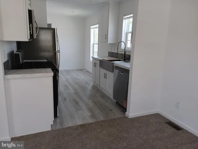 a kitchen with a refrigerator and a stove