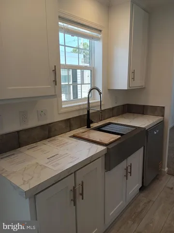 a kitchen with a sink and cabinets