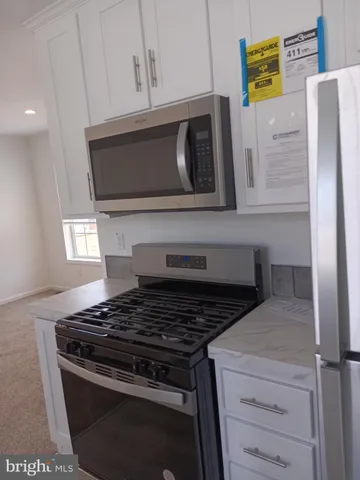 a kitchen with a stove and a microwave