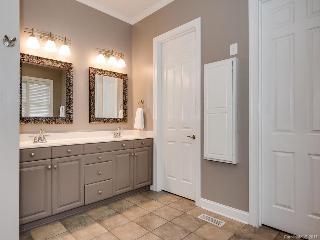 1940 Clark Elliot Street Fort Mill, SC 29708 - Photo 14 of 22 a spacious bathroom with a mirror a sink and a mirror