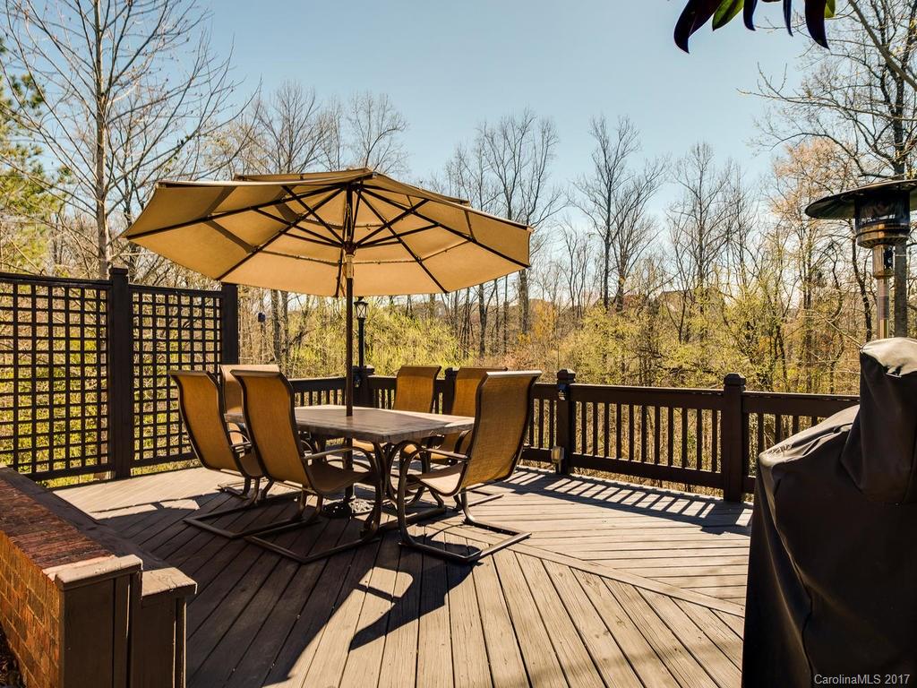 1940 Clark Elliot Street Fort Mill, SC 29708 - Photo 21 of 22 a view of a patio with table and chairs under an umbrella with wooden floor