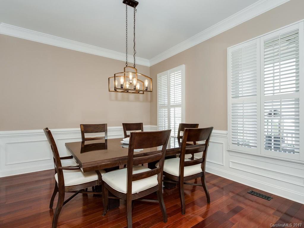 1940 Clark Elliot Street Fort Mill, SC 29708 - Photo 4 of 22 a view of a dining room with furniture a chandelier and wooden floor