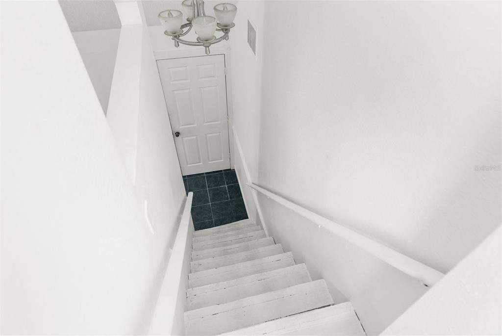 10221 Elgin Boulevard Spring Hill, FL 34608 - Photo 21 of 32 a view of staircase with white walls and white door