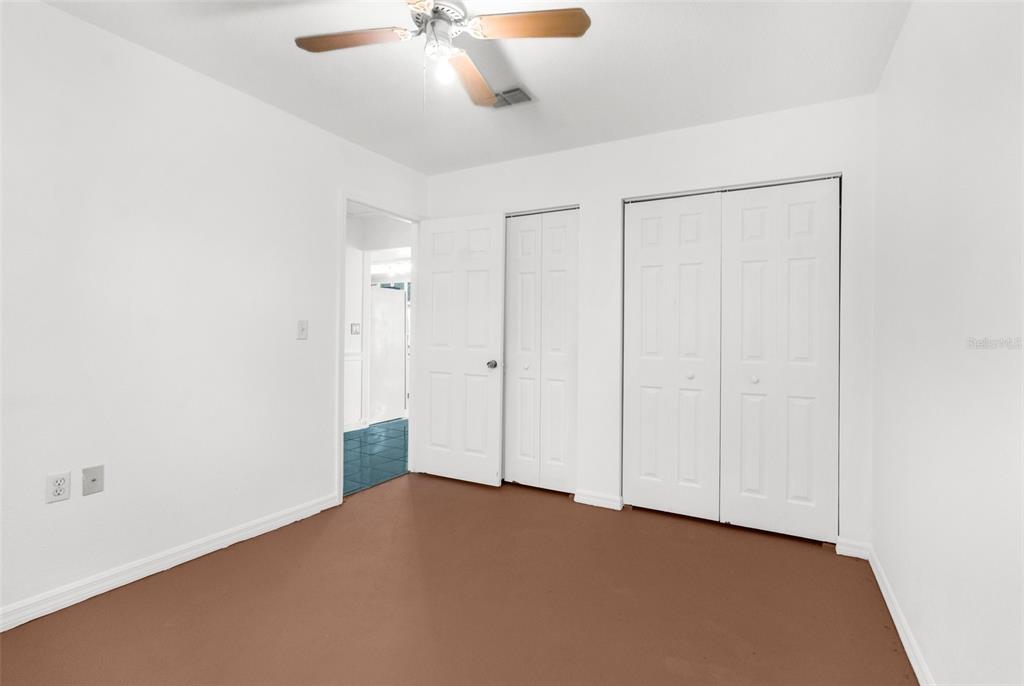10221 Elgin Boulevard Spring Hill, FL 34608 - Photo 23 of 32 an empty room with a ceiling fan