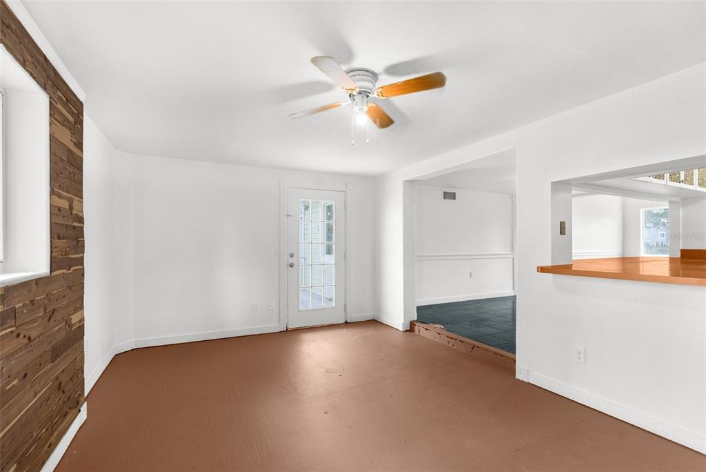 10221 Elgin Boulevard Spring Hill, FL 34608 - Photo 31 of 32 an empty room with a ceiling fan and wooden floor