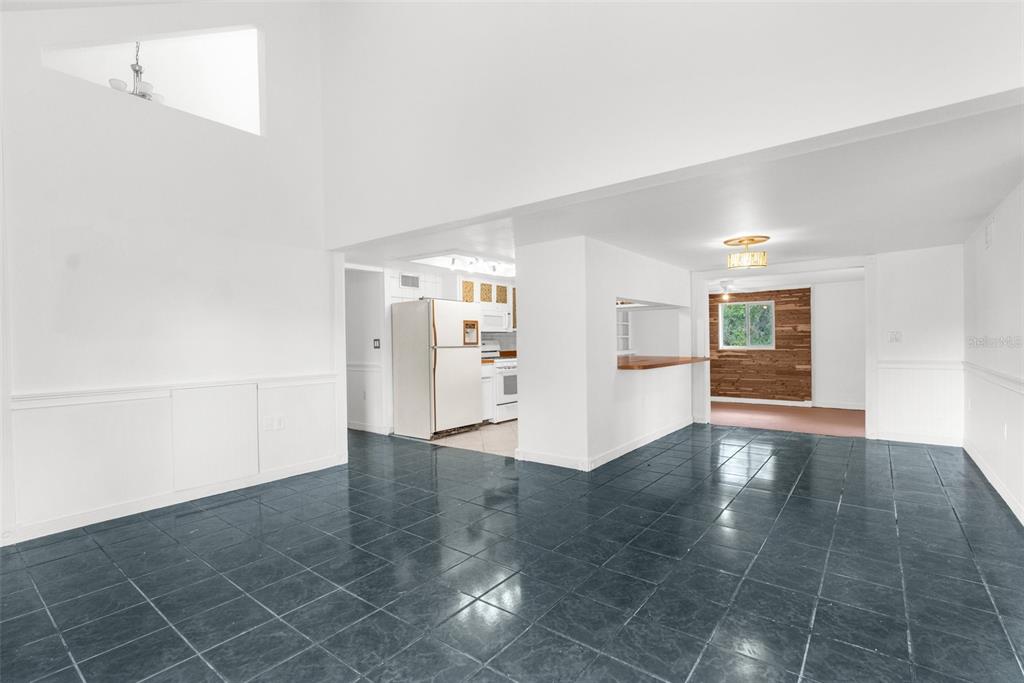 10221 Elgin Boulevard Spring Hill, FL 34608 - Photo 4 of 32 an empty room with a empty space and windows