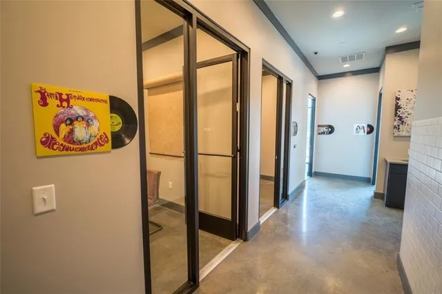 a living room with furniture a large window and a flat screen tv