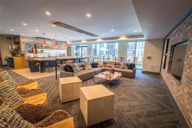 a view of a swimming pool with furniture and floor to ceiling window