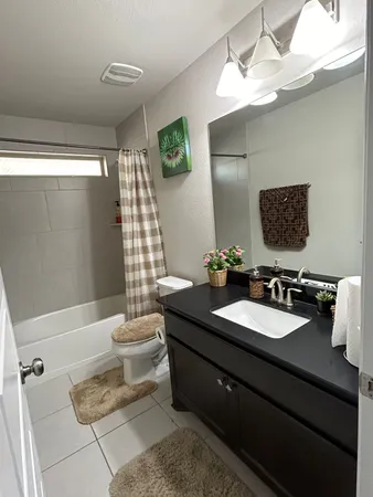 a bathroom with a double vanity sink toilet and shower