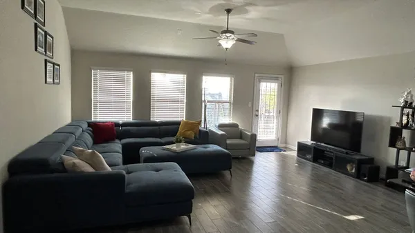 a living room with furniture and a flat screen tv