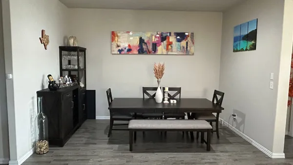 a view of a workspace with furniture and wooden floor