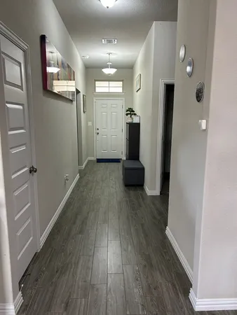 a view of hallway with wooden floor